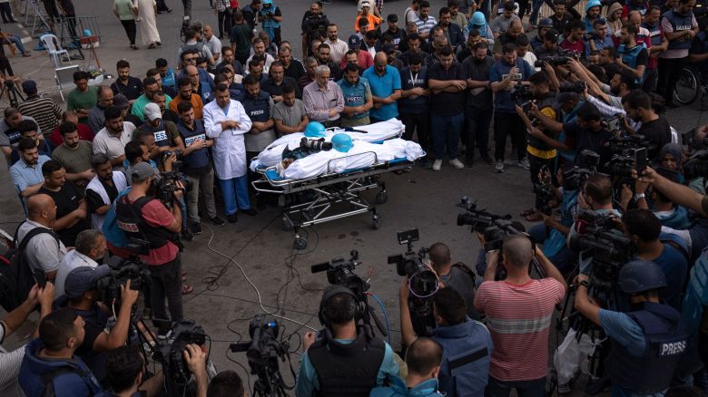 Palestinians, mostly journalists, gather around the bodies of two Palestinian reporters, Mohammed Soboh and Said al-Tawil, who were killed by an Israeli airstrike in Gaza City, Tuesday, Oct. 10, 2023. The militant Hamas rulers of the Gaza Strip carried out an unprecedented attack on Israel Saturday, killing over 900 people and taking captives. Israel launched heavy retaliatory airstrikes on the enclave, killing hundreds of Palestinians. (AP Photo/Fatima Shbair)